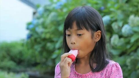 Asian Girl Eating A Popsicle.