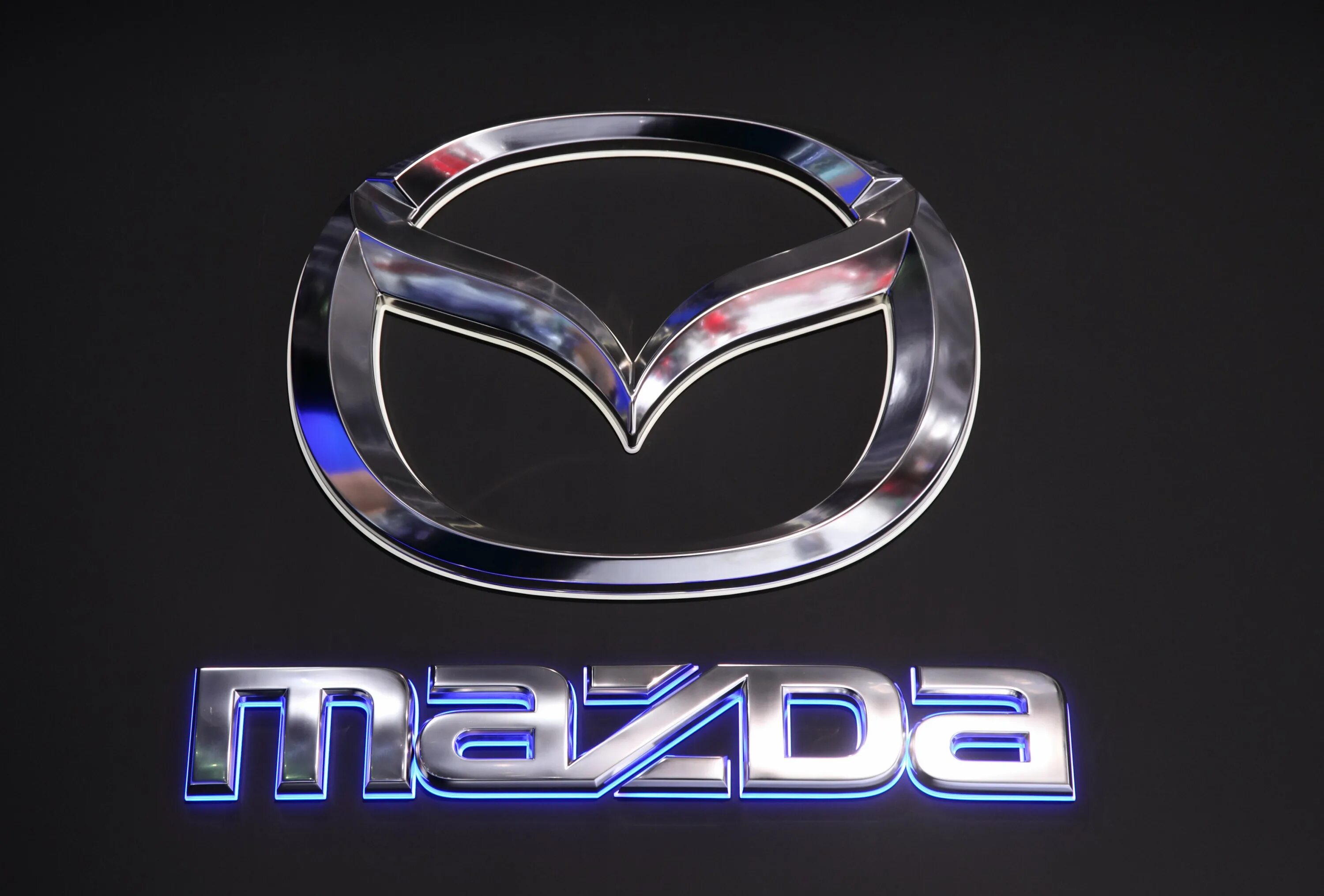 Mazda знак. Mazda эмблема. Марка машины Мазда. Значок машины Мазда. Новый логотип Мазда.