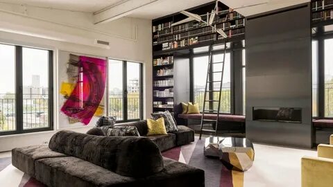 A Woman Takes Pictures In A Room With Loft Interior.
