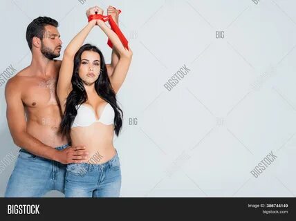 Download high-quality submissive woman tied hands near muscular images