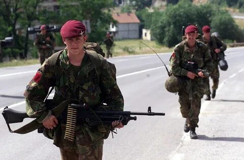 Paratroopers of the 1st Battalion, The Parachute Regiment patrol the strate...