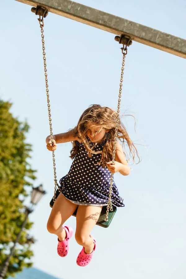 The girl got stuck on the playground. Little девушка street. on the swing. playground girls.