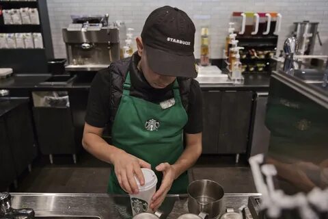 Barista Andy Acevado prepares a drink inside a Starbucks Corp. coffee shop ...