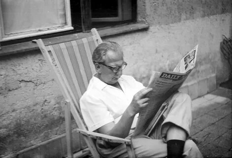 He is reading a newspaper now