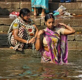 This woman was saying prayers after submerging herself in the river. 