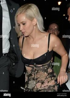 Jennifer Lawrence arrives at a club in Mayfair with ample cleavage on show ...