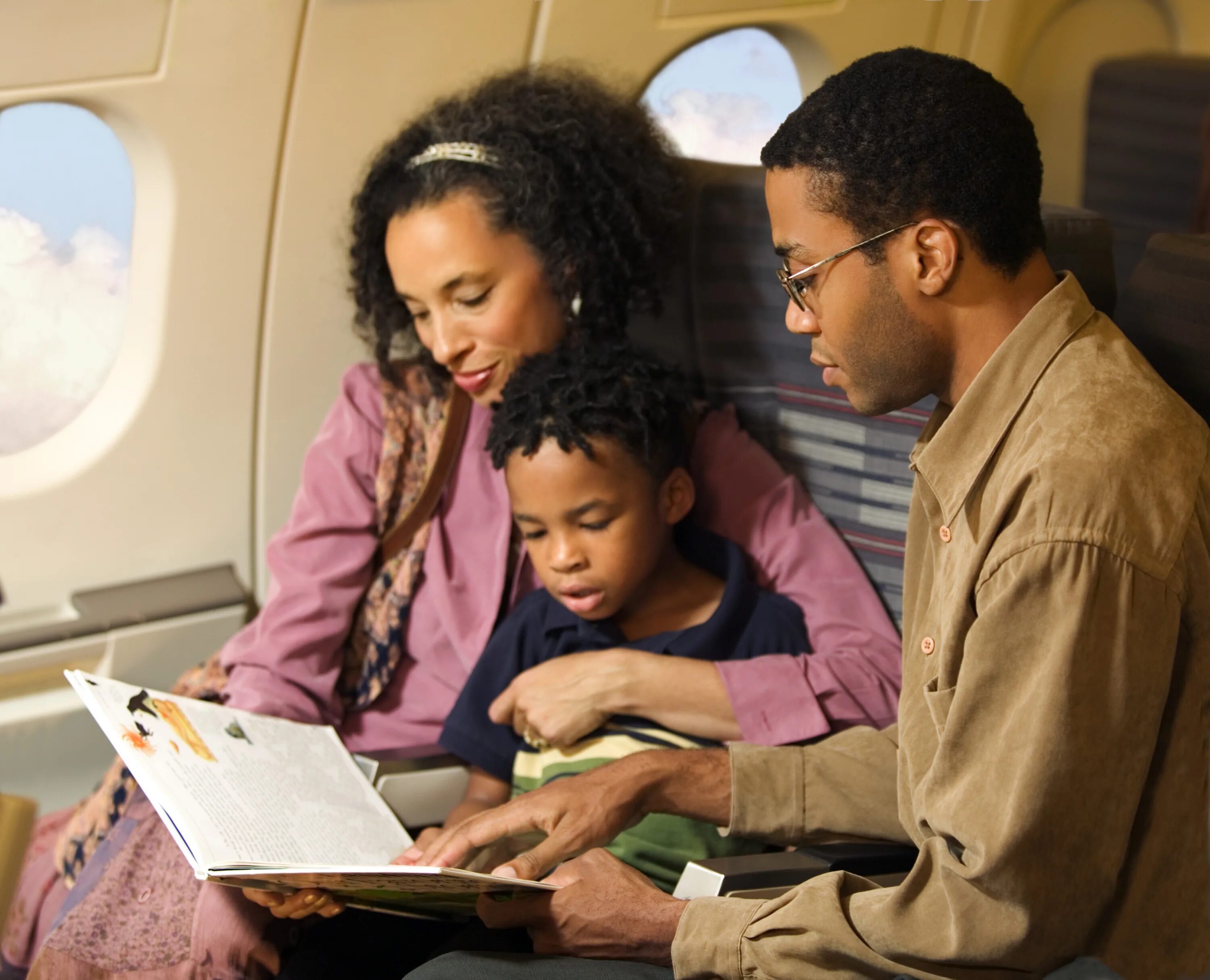 I get on the plane. Get on the plane. Family on the plane. Reading on the plane. People get on the plane.