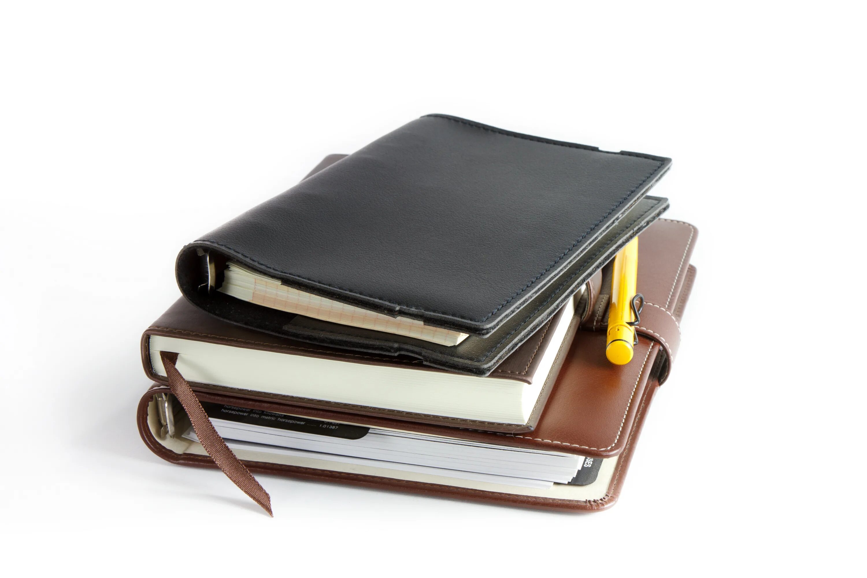 Блокнот лежит. Открытый блокнот на столе. Стопка ежедневников на белом фоне. Блокнот вид сверху. Блокнот лежит.