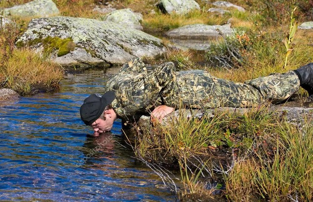 Пить из ручья. Пьет воду из ручья. Человек пьет из ручья. Человек пьет воду из ручья.