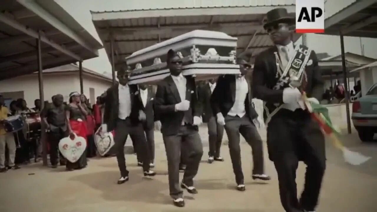 Афроамериканцы танцуют с гробом.