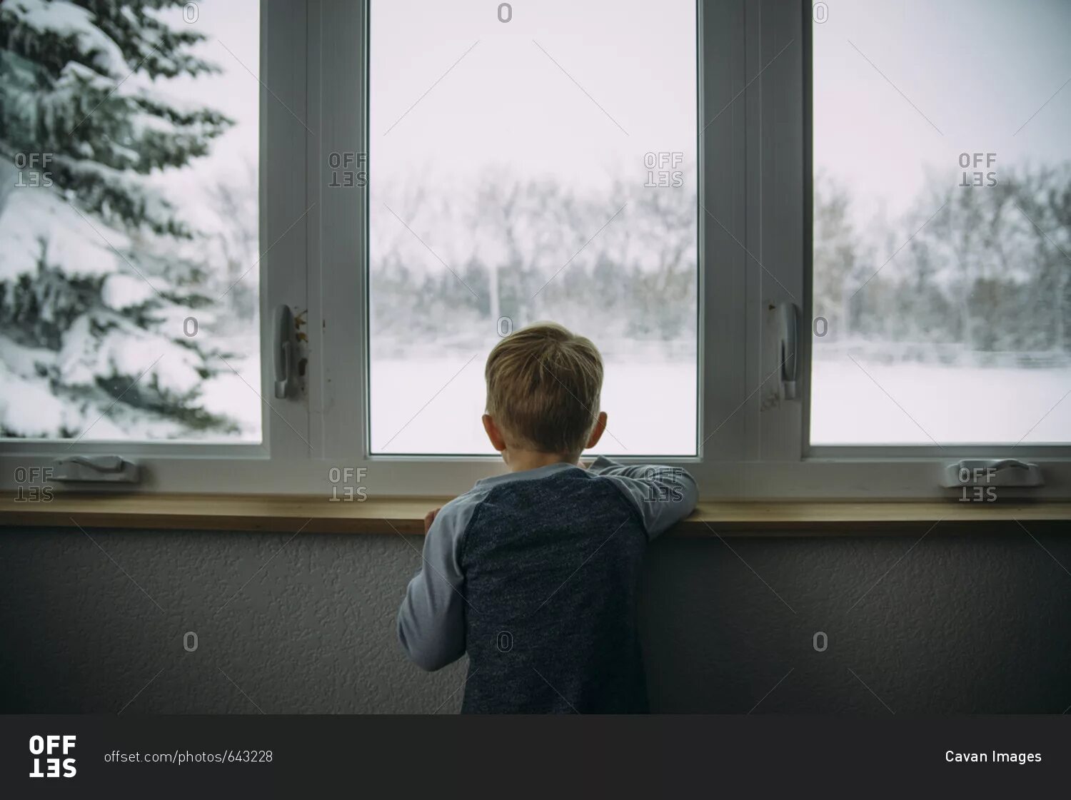 Boy behind the Window. Child standing at the Window view through the Window. Фото look out the Window. Look through the Window. I looked out of the window