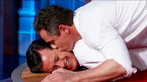 Chris Cuomo and Stephen Colbert doing push-ups. 