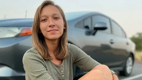 TikTok star Nikita Crump in front of her car.