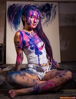 Messy Girl covered with Paint in Sleeveless Shirt and White Shorts on Webca...