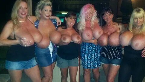 Sucking on huge fake tits.