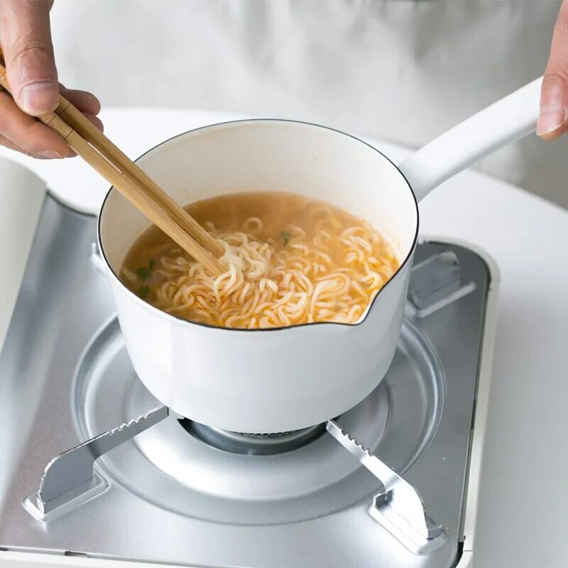 Milk pan. Женщина разливает молоко. Boiling soup. Stainless steel milk pot. Pan.