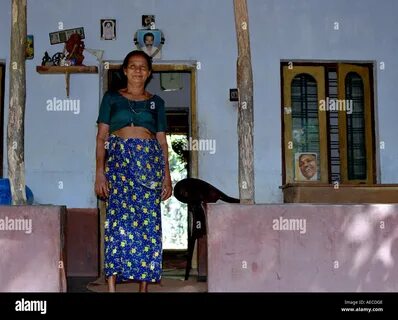 An Indian, Kerala, lady clad in traditional dress of blouse and mundu posin...