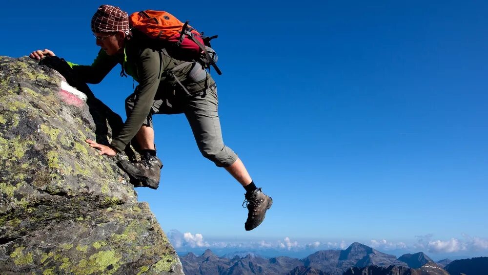 Climb up high. Трудный подъем в гору. Человек карабкается в гору. Человек в горах. Человек лезет в гору.