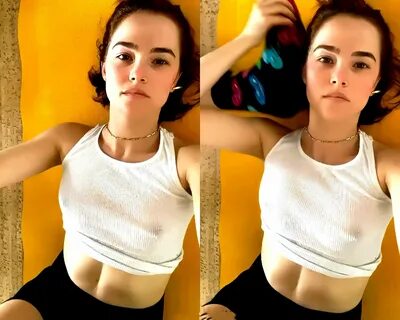 Actress Zoey Deutch shows her small tits posing in a white top without a br...