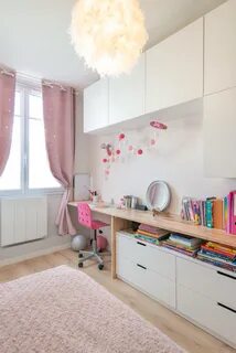 a child&apos;s bedroom with pink and white decor, bookshelves, dressers and...