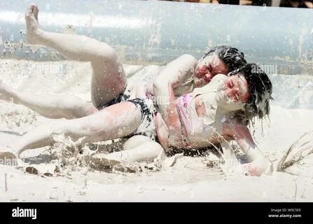 Two Chinese women wrestle in a mud pool during an interntional womens mud w...