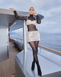 The Skims founder paired her mesh bodysuit with pointy-toe booties. kimkard...