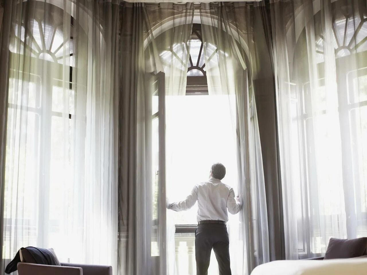 Мужчина спиной у окна. Look out of the window. A man looks out of the window at the city. Looks out his window. Тревога.