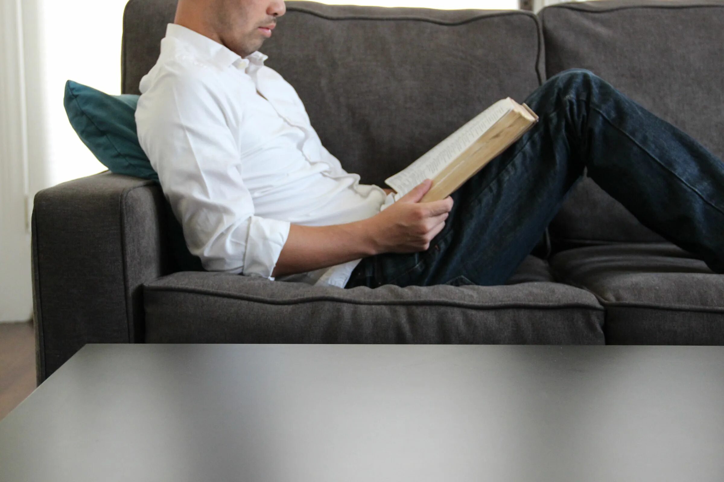 He is on the sofa. Мужчина сидит на диване. man sofa. sitting on the sofa. дремлет сидя.