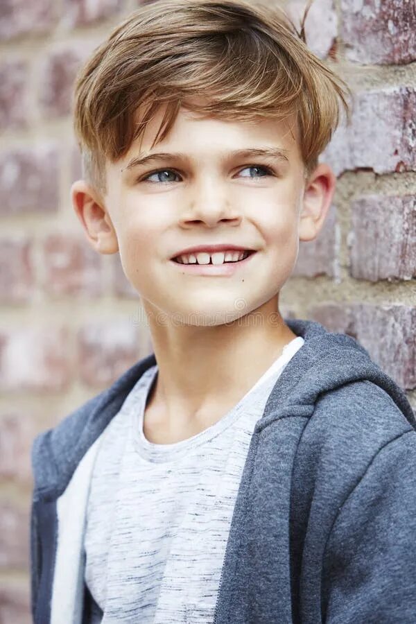 Portrait of a Young Boy Against Brick Wall Stock Image - Image of front, brick: 