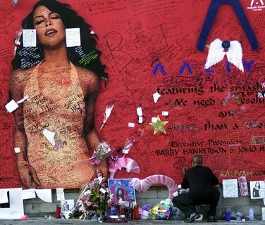Aaliyah: Aaliyah's fans sign a mural commemorating her life. 