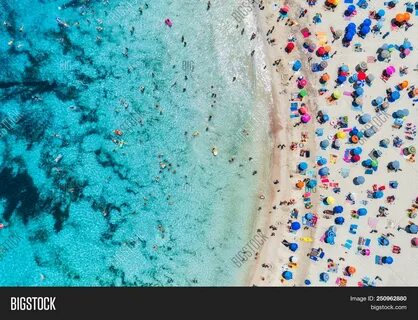 Aerial View Of Sandy Beach With Colorful Umbrellas, Swimming People In Sea ...