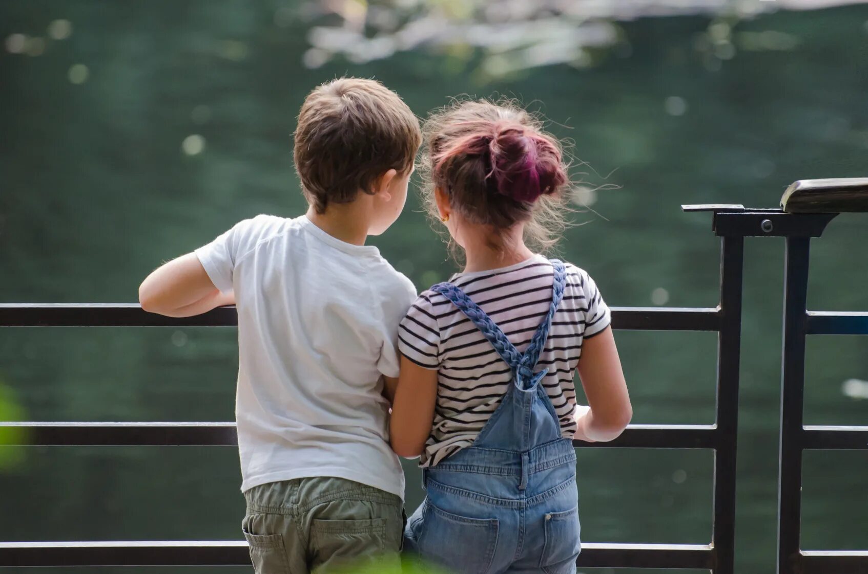 Boy looking up. Two boys looking. Kids siblings boy and girl. A boy looking at the Sea. Boy end girls