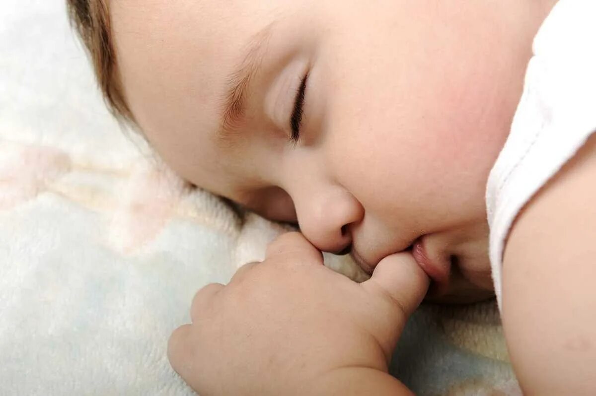 Спящий младенец. Сосательный рефлекс у младенца. Младенец с пальцем во рту. Сосательный рефлекс у детей