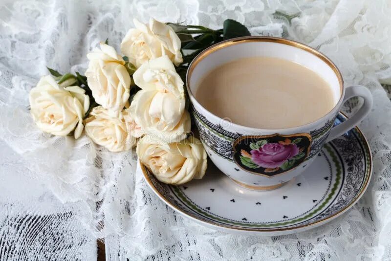cup of coffee and a bouquet of white roses - Buy this stock photo and explore si