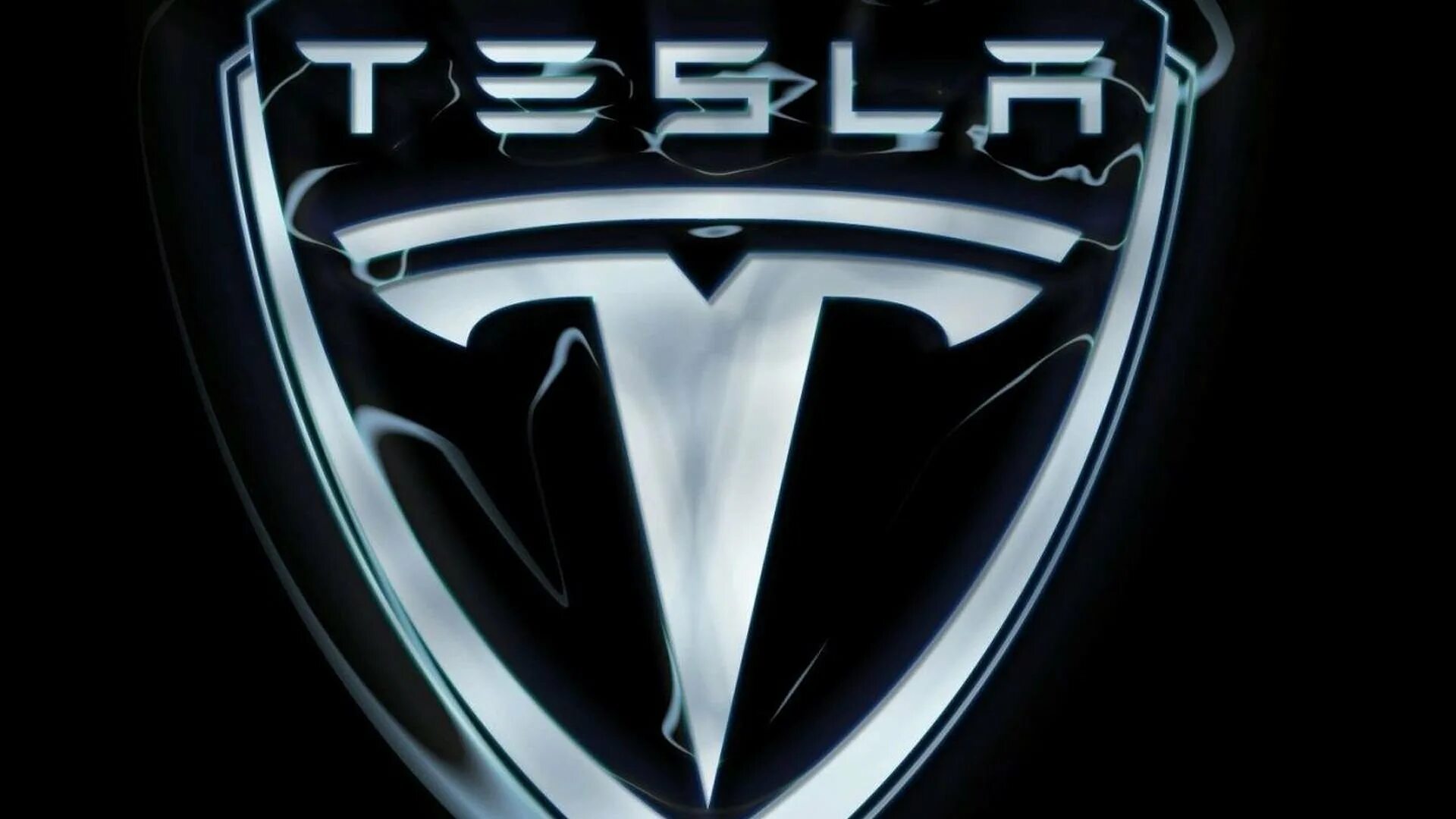 Тесла значок. Тесла Моторс логотип. Тесла марка автомобиля. Эмблемы КРУТЫХ автомобилей.