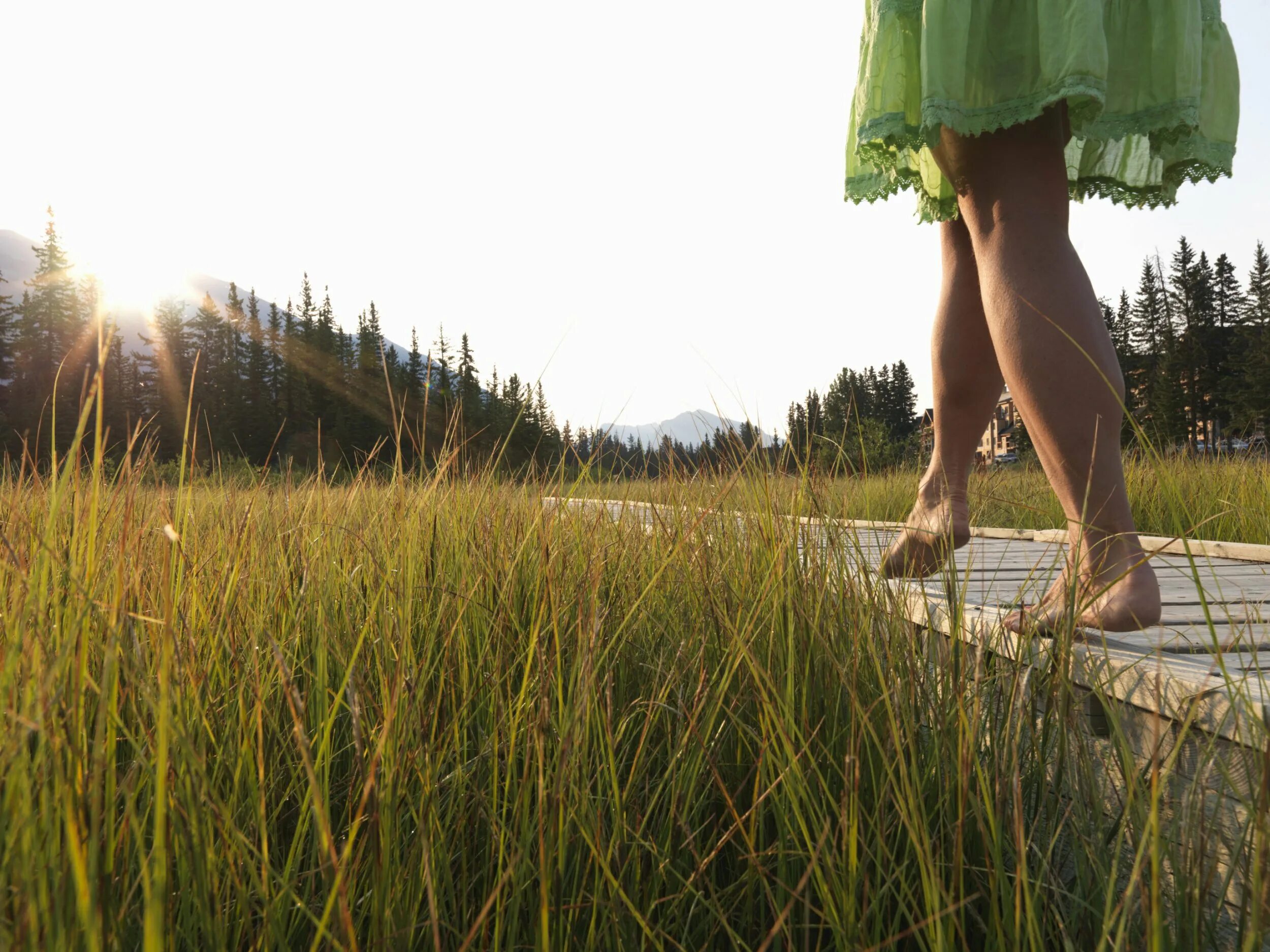 Relaxing walks. Barefoot teen on grass. Bare bottom woman walk.