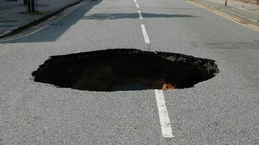Движение яма. Яма в асфальте. дыра в дороге. огромная яма на дороге.
