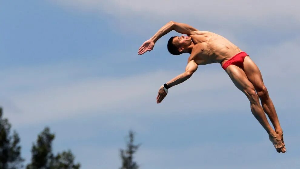 Выскочивший человек. Человек в прыжке. Прыжки в воду. Мужчина в прыжке. Спортсмен в прыжке.