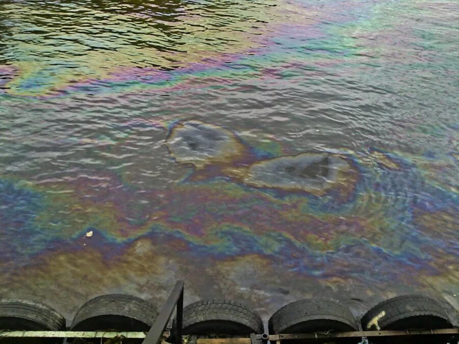 Разлив нефти на поверхности воды. Масляная пленка на воде. Нефтяные пятна на воде.