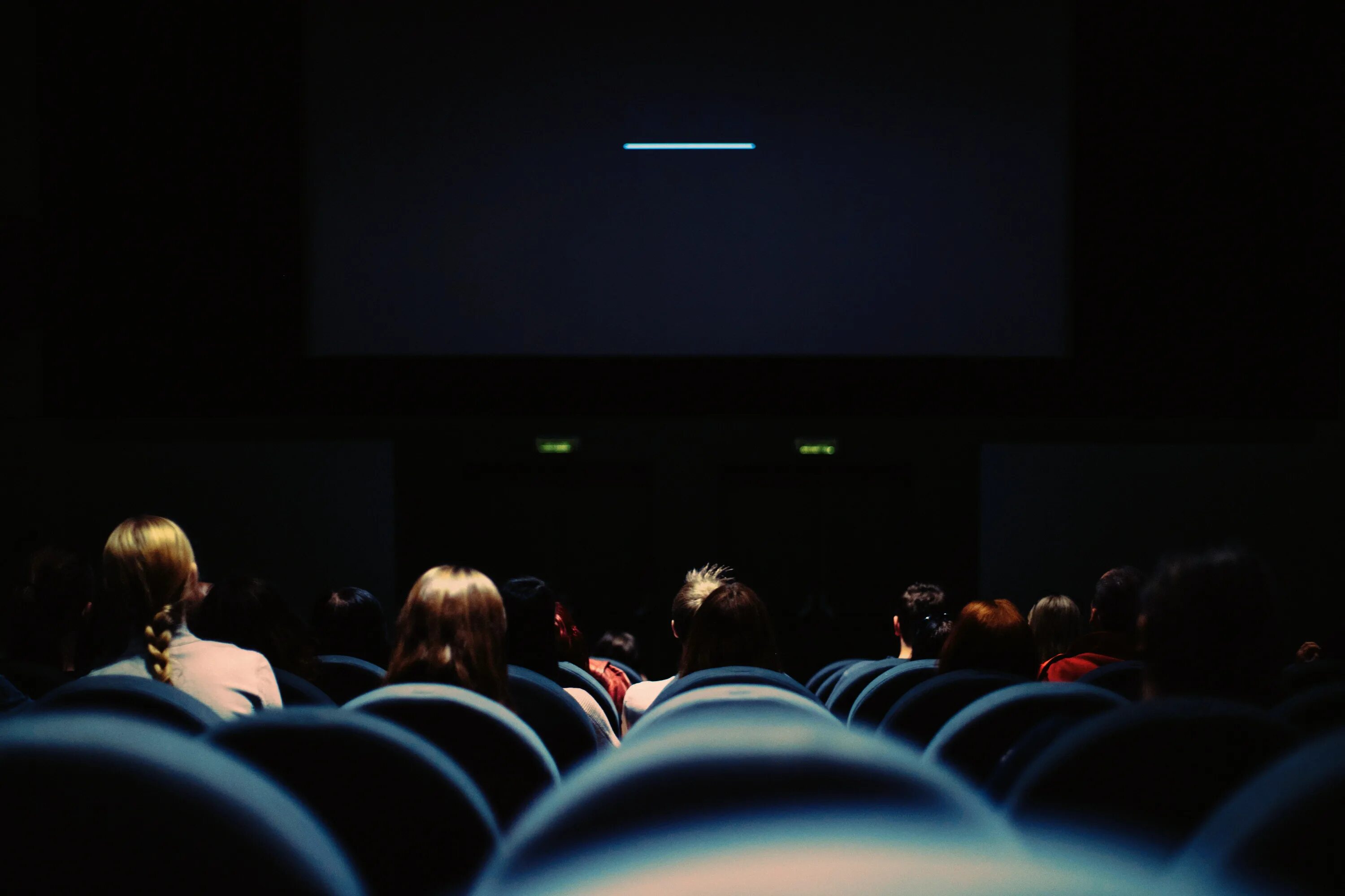 Приобретение у дистрибьютеров прав показа кинофильмов. Кинотеатр полный зал. Зал кинотеатра с людьми. Экран кинотеатра с людьми. Люди в кинотеатре.