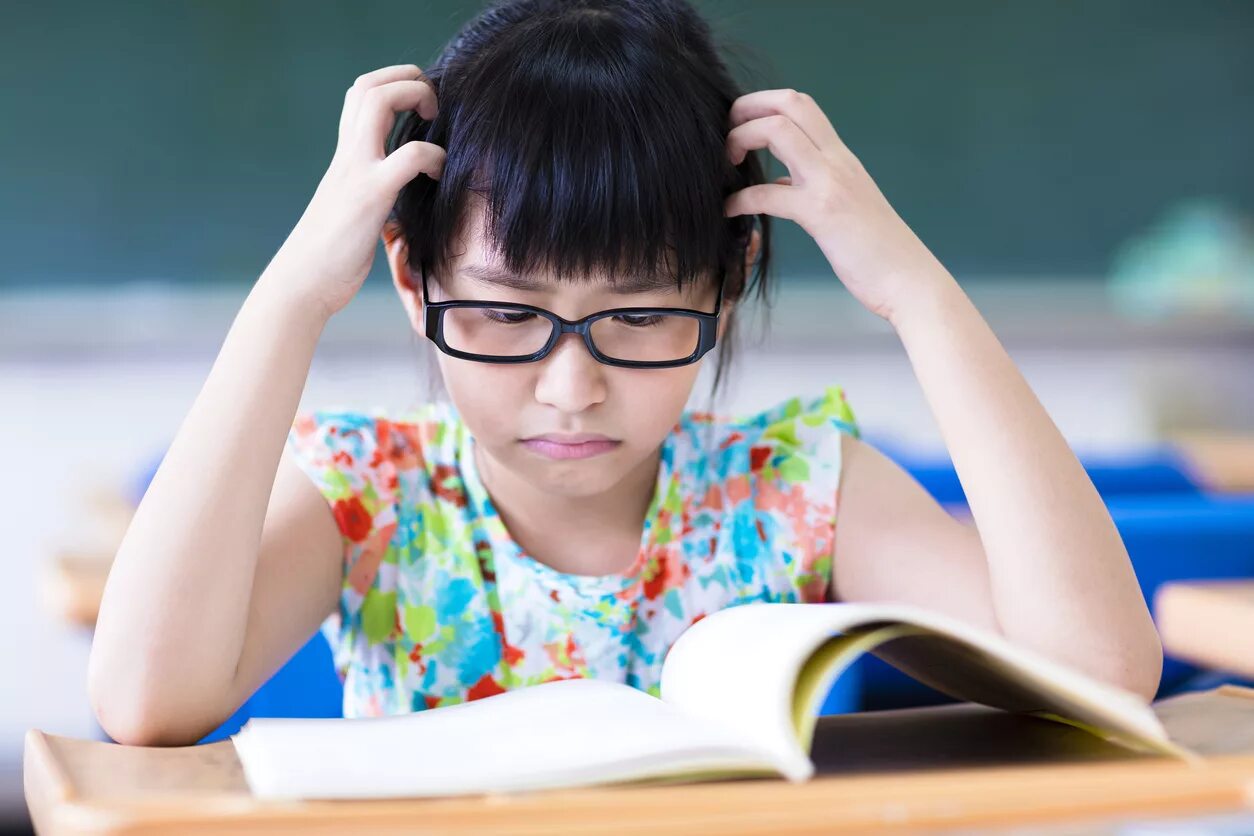 She is learning to read. Азиатка пожилая учеба с книгой. ученики грустный с книгой фото. hate reading.