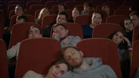 People Watch Boring Movie At Cinema In Slow Motion Group Of Young.