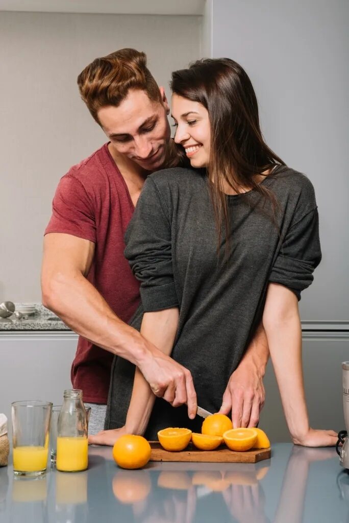 Wife cooking. Пара готовит. Woman hugging man from behind. Nice hug behind.