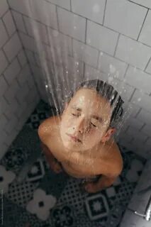 High angle view of a boy taking a shower at home. 