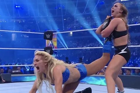 Ronda Rousey grapples with Charlotte Flair at WrestleMania. 