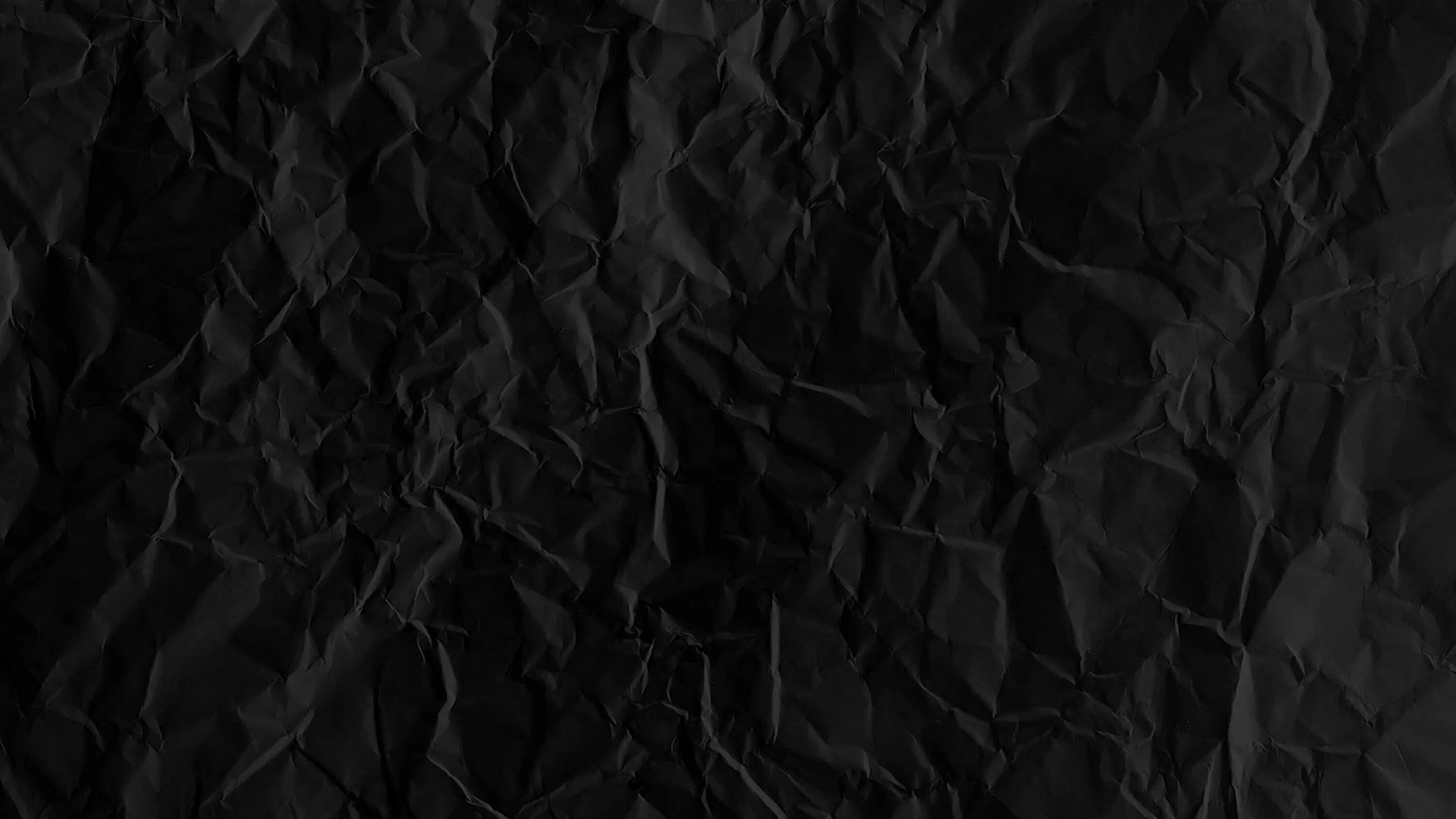 Темный фон. Черная мятая бумага. Черные обои. Черная текстура. Black page