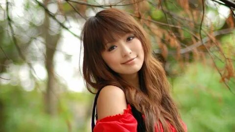 A sweet photo of a pretty girl from Japan smiling in a red off-shoulder top...