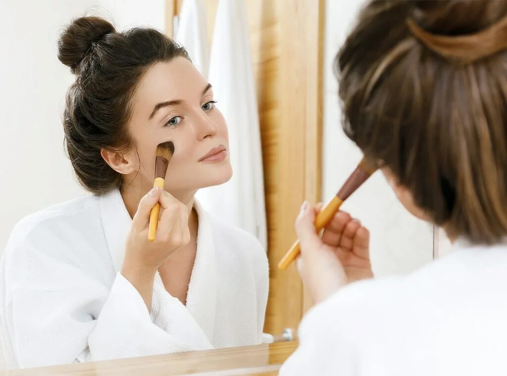 Applying make up. Makeup Foundation stroke. Look in the Mirror and make up. Apply Foundation.