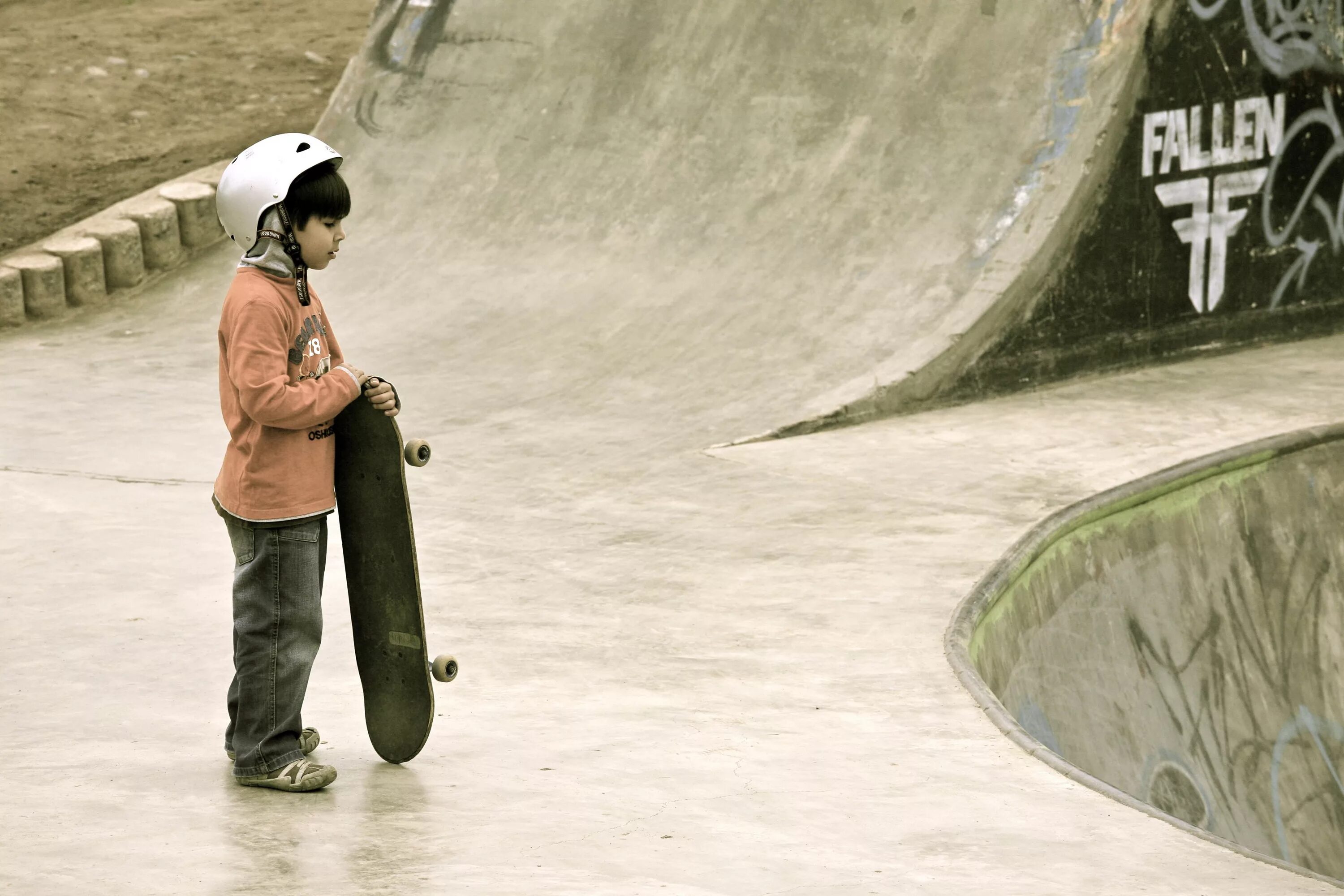 The most ideal. Kids in Skateboard. The child held the Edge of the Bowl between his fingers.