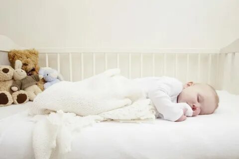 Baby girl sleeping in crib.